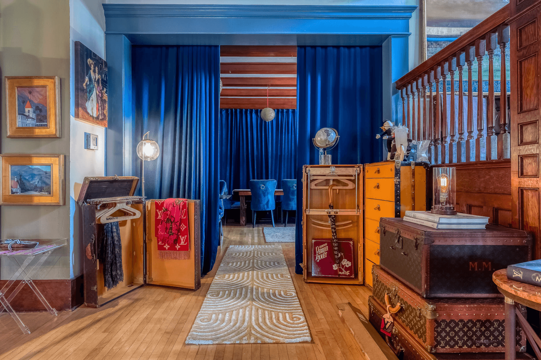 Common area leading to dining room set behind dark blue curtains